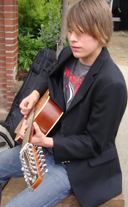 A young musician plays his guitar. He was GOOD!